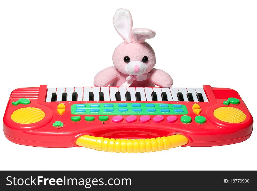 Isolated pink rabbit with a bent ear, and synthesizer. Isolated pink rabbit with a bent ear, and synthesizer
