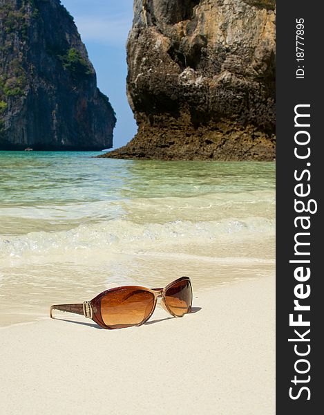 Sunglasses on a background of sea and mountains. Sunglasses on a background of sea and mountains