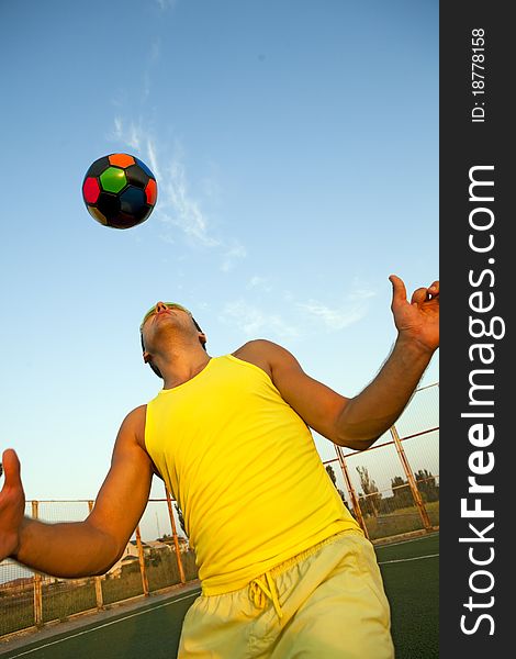 Football player shooting a ball with his head