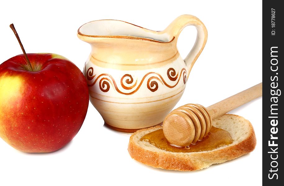 Honey in a jug and apple isolated on white background