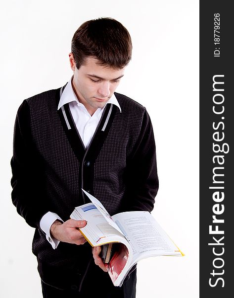 A university college student or casual man reading or studying a textbook.