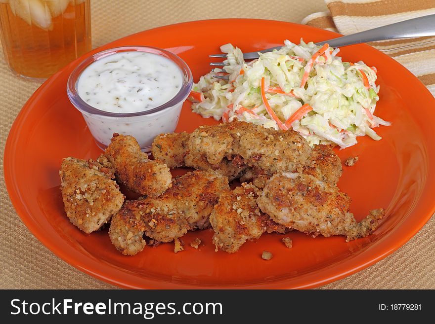 Chicken strip meal with dipping sauce and coleslaw