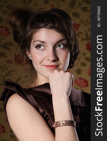 Portrait of the beautiful stylish brunette woman in brown dress