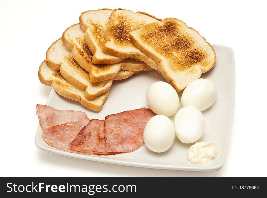 Breakfast. Toasts, eggs, bacon on white background