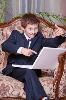 Happy Business Boy Pointing In Computer Screen Royalty Free Stock Photography