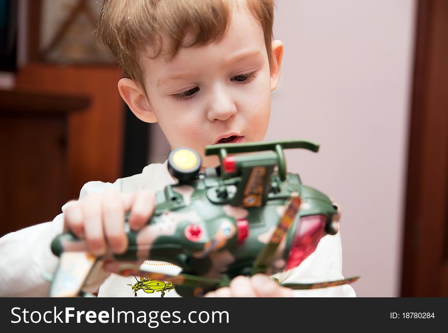Little boy with toy helicopter