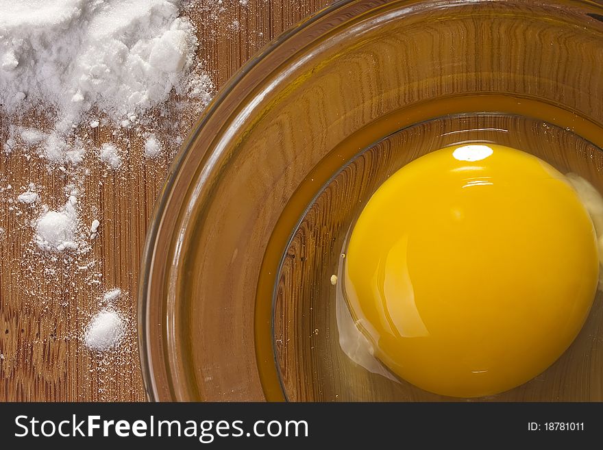 One egg yolk in a glass dish.