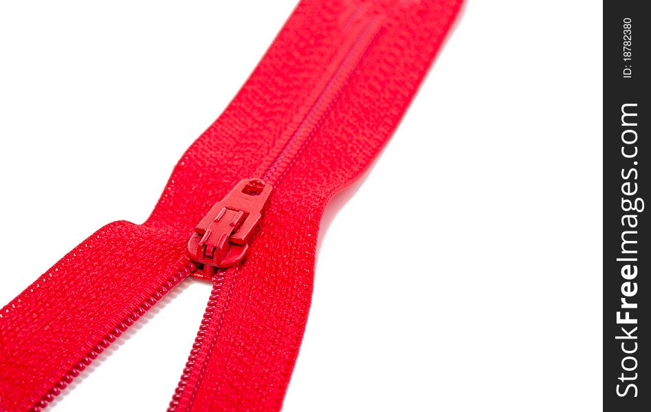 A close up of a red zipper isolated over white