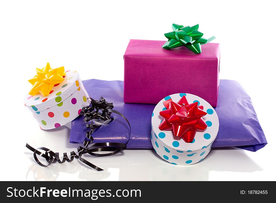 Colorfully decorated gifts with ribbons and bows isolated over white