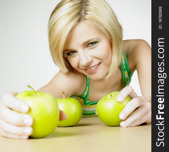 Portrait of young woman with apples