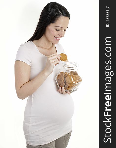 Pregnant woman looking in cookie jar isolated on white. Pregnant woman looking in cookie jar isolated on white