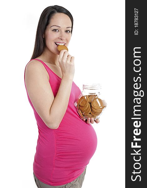 Pregnant woman looking to camera enjoying a biscuit. Pregnant woman looking to camera enjoying a biscuit