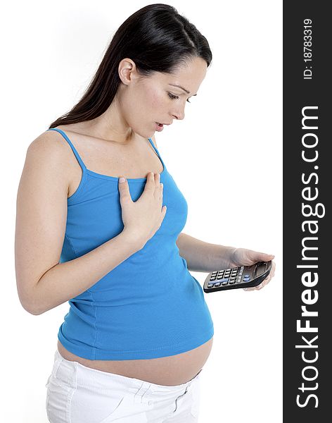 Pregnant woman looking shocked at calculator. Pregnant woman looking shocked at calculator