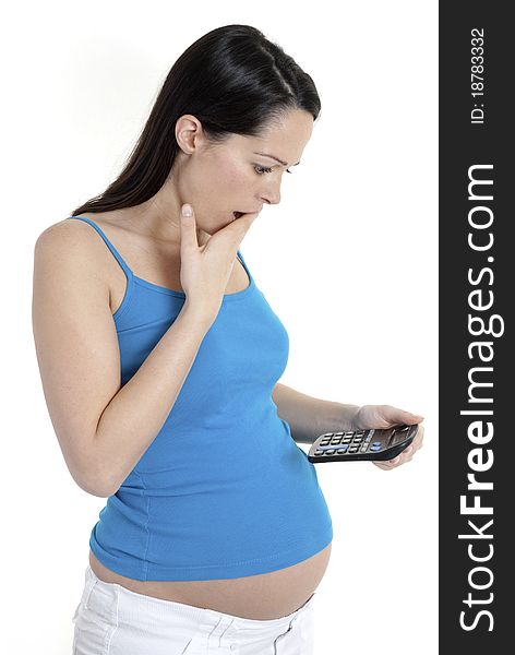 Pregnant woman looking shocked at calculator. Pregnant woman looking shocked at calculator