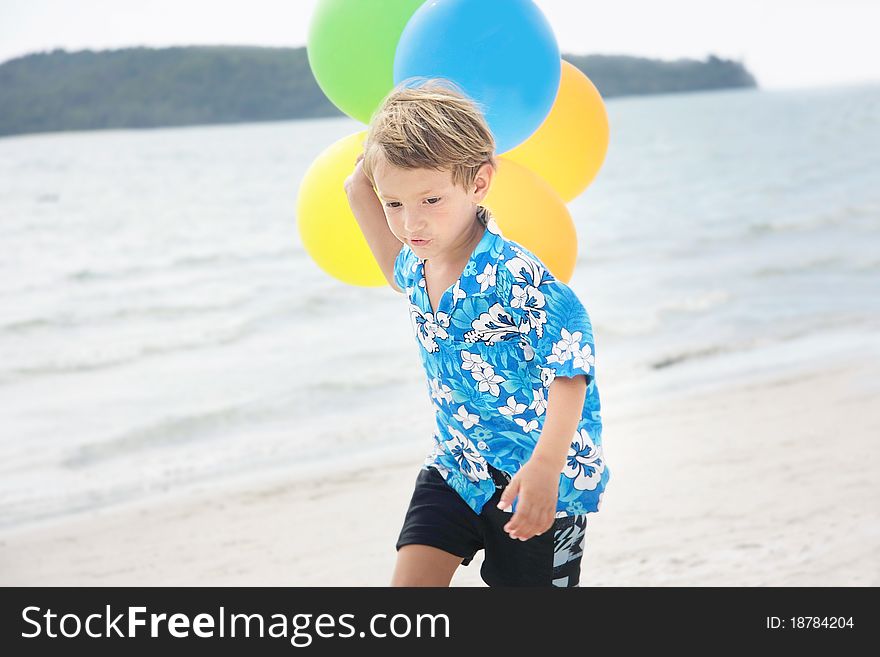 Young Happy Boy Running With Balloons