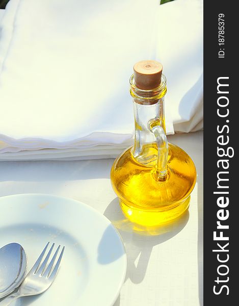 An olive oil bottle on table