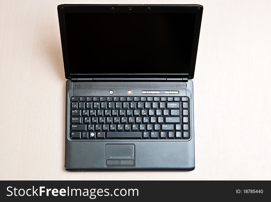 Black laptop on an office wood desk. Black laptop on an office wood desk