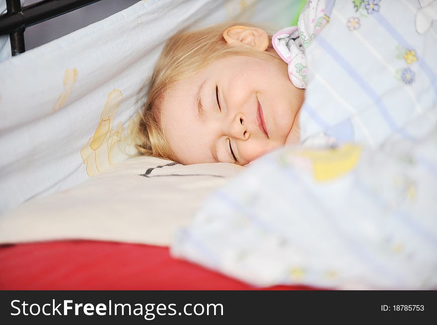 Cute little girl sleeping in bed