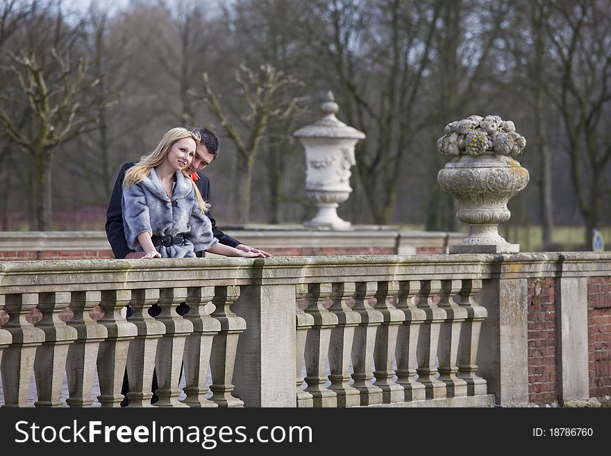 Young happy couple embracing on the bridge. Young happy couple embracing on the bridge