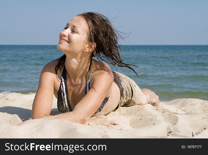 Young woman lying on a beach. Young woman lying on a beach