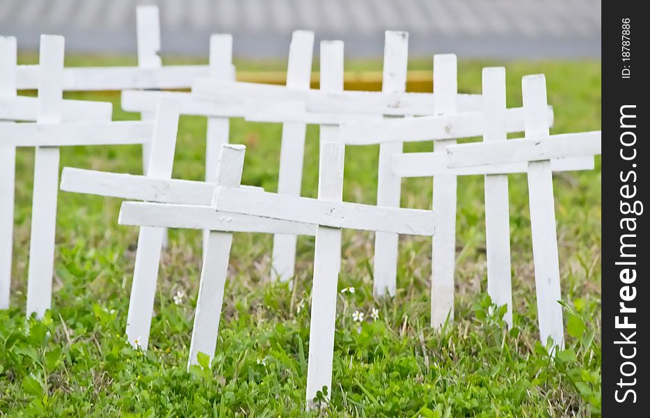 Crosses lined up on the side of the road.