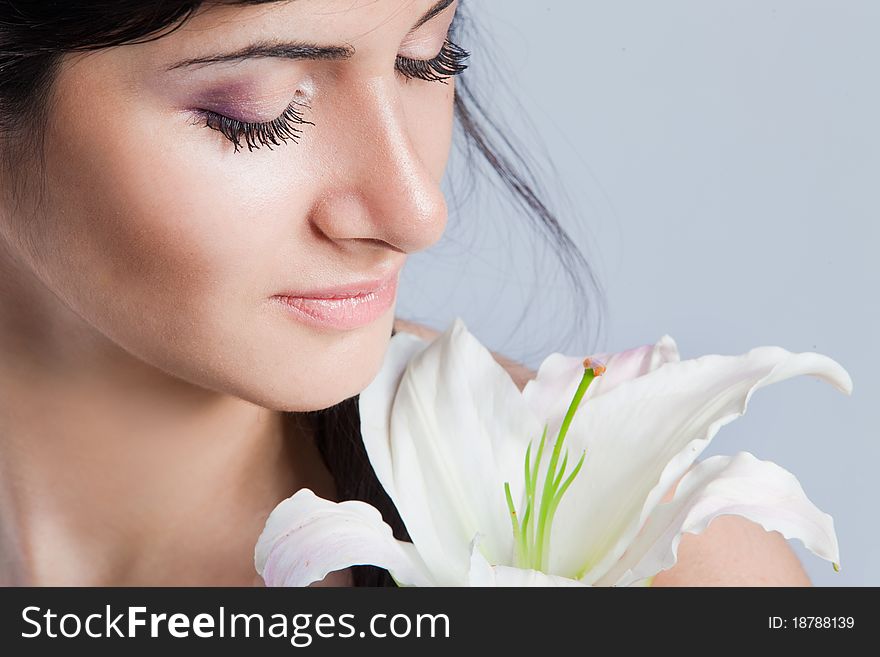 Beautiful young woman with fresh clean skin and white flower. Beautiful young woman with fresh clean skin and white flower