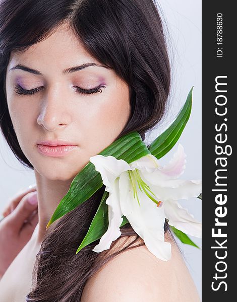 Beautiful young woman with fresh clean skin and white flower. Beautiful young woman with fresh clean skin and white flower