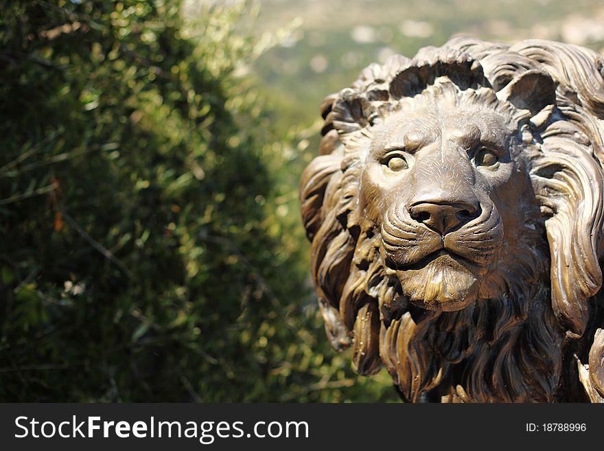 Lion statue in park park on background