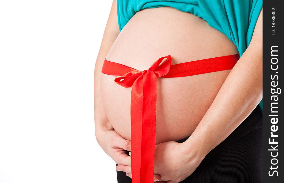 A red bow on the belly of a pregnant woman. Isolated on a white background