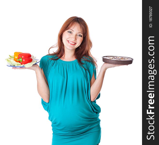 A pregnant smiling young woman is holding food in her hands. Isolated on a white background. A pregnant smiling young woman is holding food in her hands. Isolated on a white background