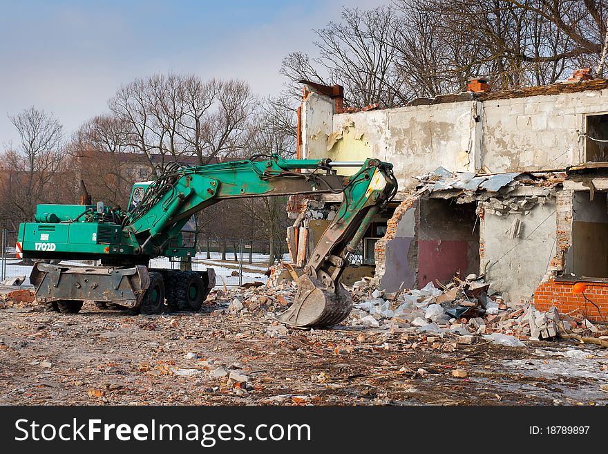 Excavator at the abandoned demolished home