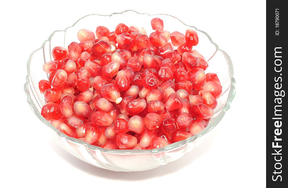 Pomegranate seets inside a glass plate isolated on a white background