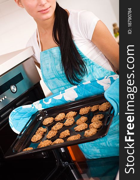 Woman In The Kitchen Baking Cookies.