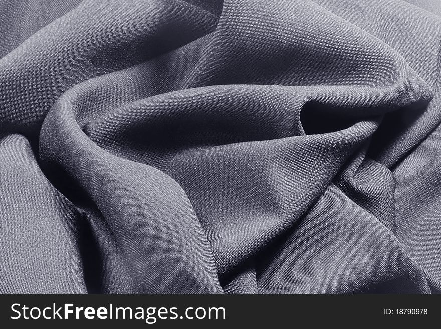 A close up of dark gray crumpled fabric. A close up of dark gray crumpled fabric