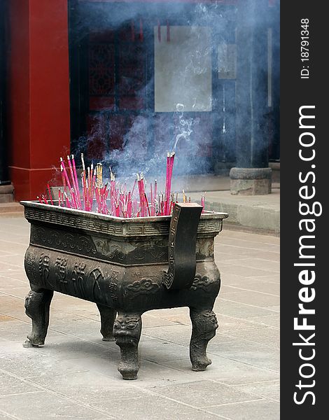 A box with burning incense in a temple in Chengdu, China. A box with burning incense in a temple in Chengdu, China.