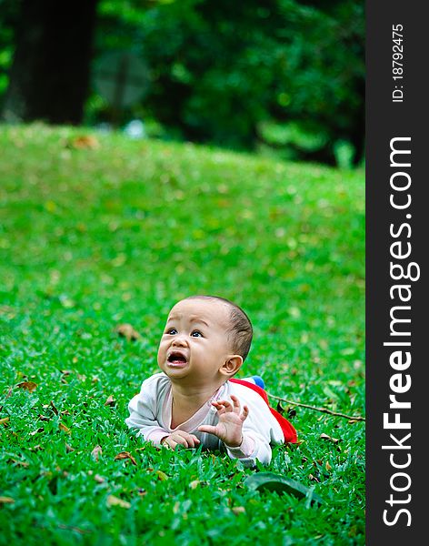 Baby boy is playing in a park after feeding time. Baby boy is playing in a park after feeding time