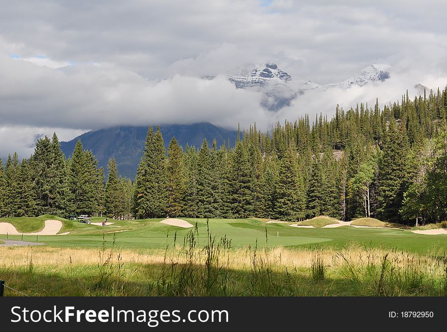 A Rocky Mountain golf green fronted and surrounded by bunkers. A Rocky Mountain golf green fronted and surrounded by bunkers