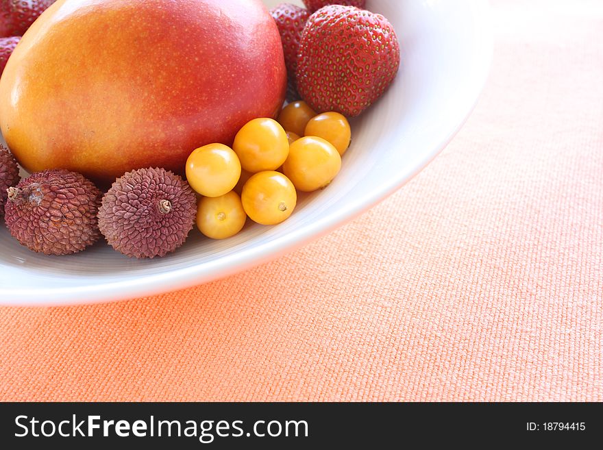 Variety of fresh fruits in a white bowl