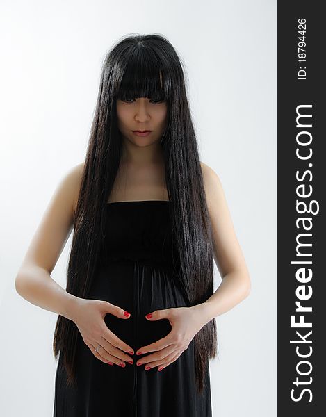 Portrait of asian pregnant woman on grey