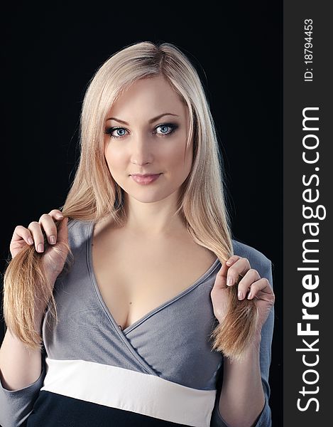 Portrait of beauty blonde girl on black background
