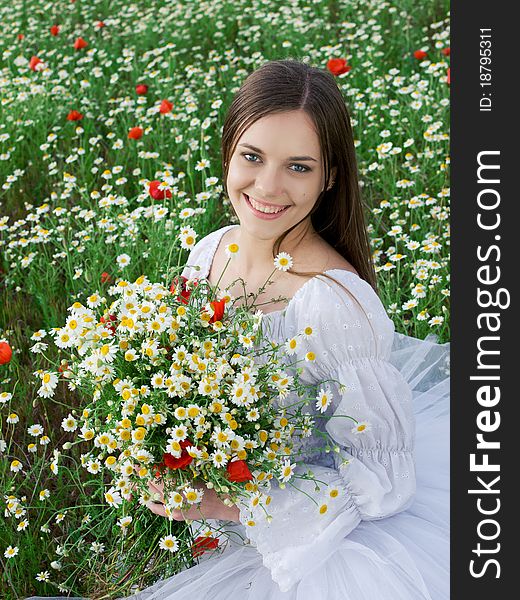 Young happy girl with bouquet in daisy field. Young happy girl with bouquet in daisy field