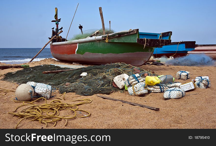 Fishermans boat and tackle including nets left on a beach for next trawl. Fishermans boat and tackle including nets left on a beach for next trawl