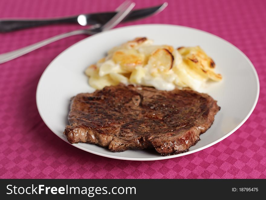 Beef with potatoes on pastel tablecloth