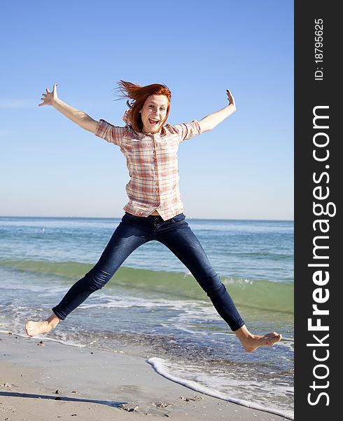 Young Beautiful Girl Jumping At The Beach.