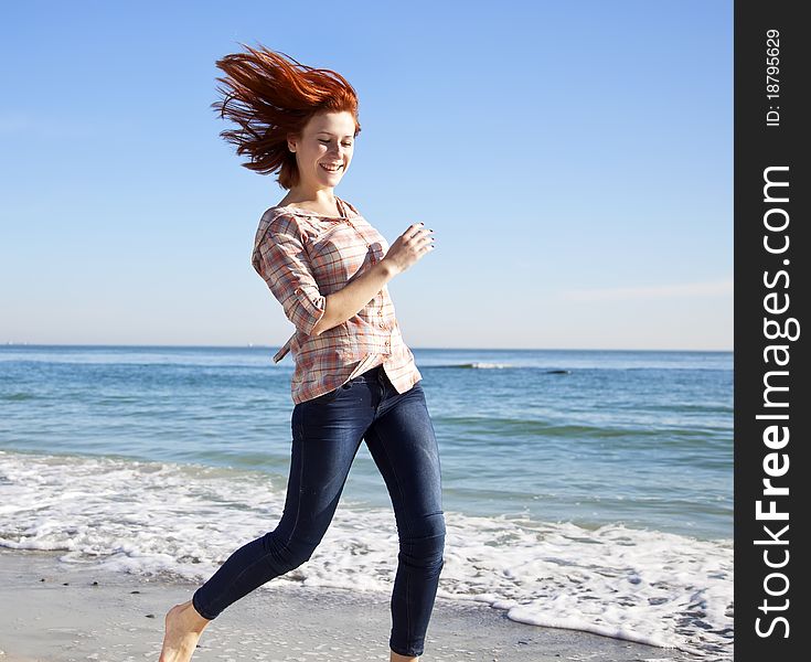 Beautiful Young Woman Running On The Beach