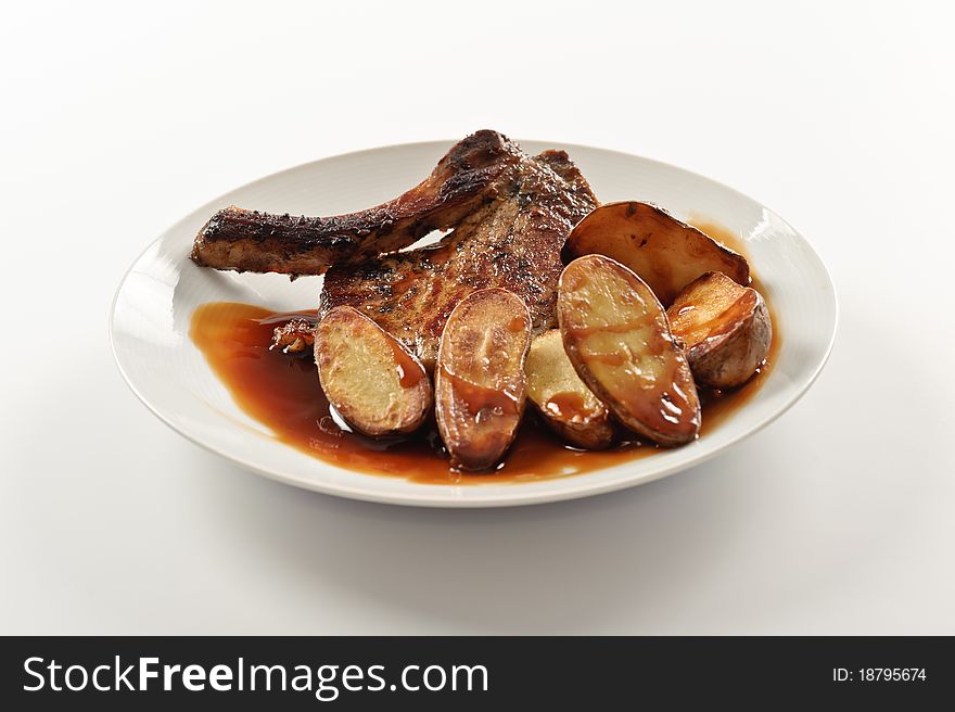 Porkchop with potatoes on white background