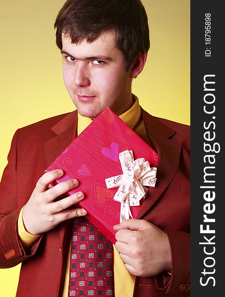 Boy with present box. Studio shot.