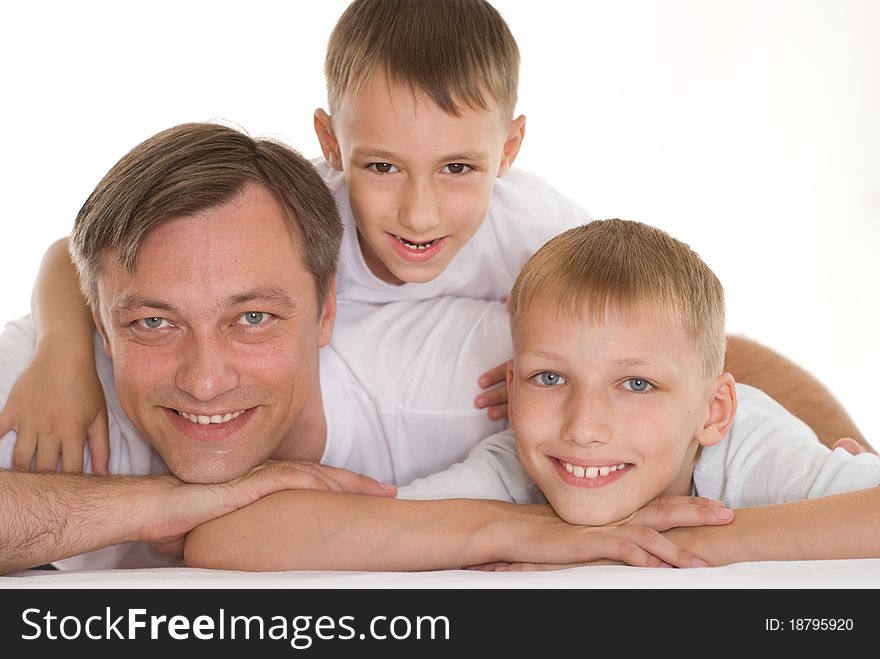 Father with his two sons standing on a white