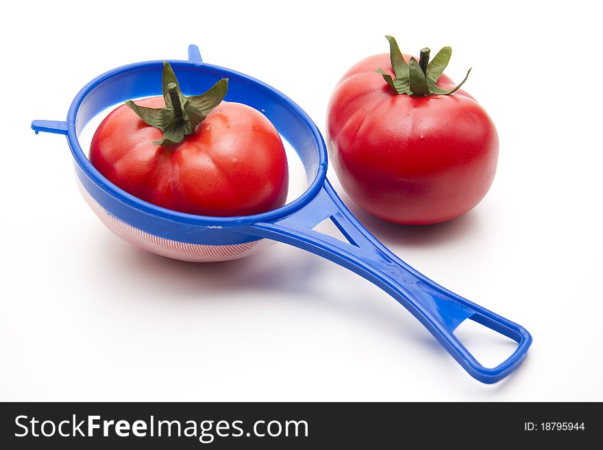 Tomato in the kitchen sieve of plastic