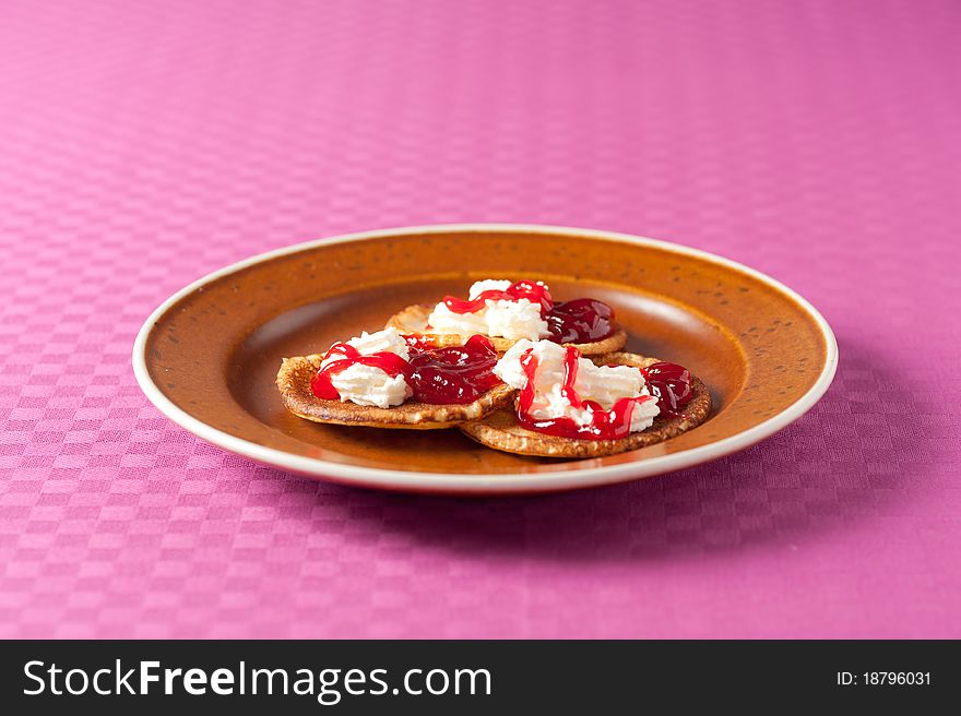 Mess of unhealthy pancakes with jam and cream. Mess of unhealthy pancakes with jam and cream